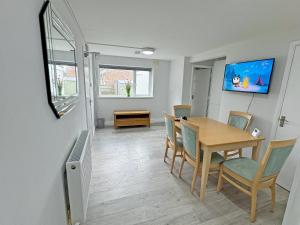a dining room with a table and chairs at Riverside Cottage in Spalding