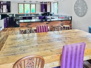 a kitchen with a large wooden table and chairs at Grantham House in Grantham