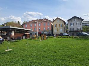 a park with chairs and tables in the grass at La Parenthèse Lémantine - Studio 3 in Neuvecelle