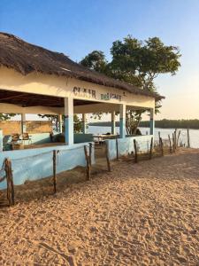 a restaurant on the shore of a beach at Campement Clair de Lune - Chez Dam et Amcé in Kachiouane