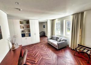 a living room with a couch and a table at Parkhotel Steimker Berg Wolfsburg in Wolfsburg
