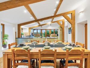 a dining room with a large wooden table and chairs at Knoll View Ranch in Shepton Mallet
