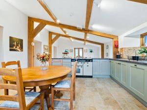 a kitchen with a wooden table and chairs at Knoll View Ranch in Shepton Mallet