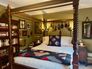 a bedroom with a bed with a wooden canopy at Burnt Toast Inn and Washington House in Ann Arbor
