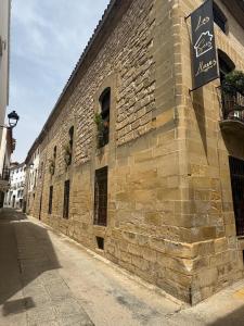 a brick building with a sign on the side of it at Las 6 llaves in Baeza