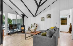 a living room with a couch and a table and a tv at Holiday Home Østmarken Toftlund Denm in Toftlund