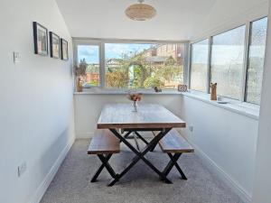 a table in a room with two windows at Longshore in Runswick