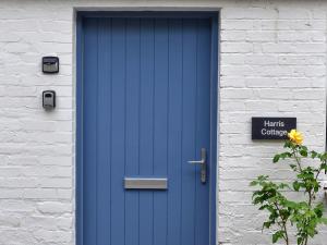 a blue door on the side of a building at Harris Cottage - Uk40056 in Aberfeldy