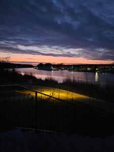 a view of a body of water at sunset at Navy Blue Dream - SPA - Basen - Parking in Dziwnów +26 photos