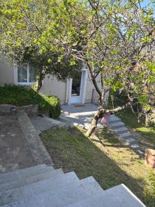 a tree in front of a house with some stairs at Appartement Bastia Cardo Village in Bastia