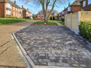 a cobblestone street in a residential neighborhood with houses at The Lobster Pot in Shotley Gate