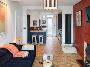 a living room with a couch and a kitchen at The Lobster Pot in Shotley Gate
