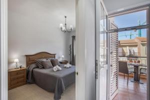 a bedroom with a bed and a balcony at Memorable Holidays With Your Family in Maspalomas +36 photos