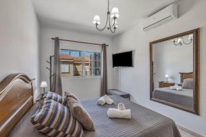 a bedroom with a bed and a large mirror at Memorable Holidays With Your Family in Maspalomas
