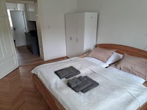 a bedroom with a bed with two towels on it at Apartmán Bezručka in Třinec