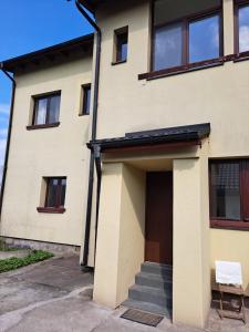 a house with a door and a chair in front of it at Apartmán Bezručka in Třinec +2 photos