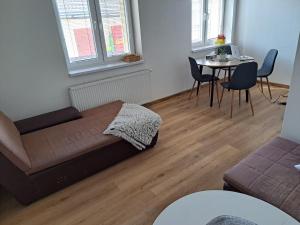 a living room with a bed and a table at Apartmán Bezručka in Třinec