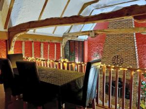 a dining room with a table and chairs at Clamp Farm Barn in Stowmarket