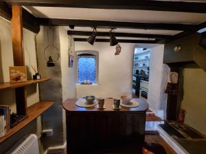 a kitchen with a small island in the middle at River Cottage in Llanbedr