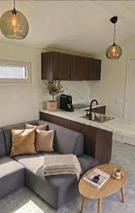 a living room with a couch and a table at The Wellness View! in Hoogersmilde