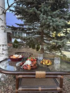 a table with a plate of food on it at Infinity Hotel in Cholpon-Ata