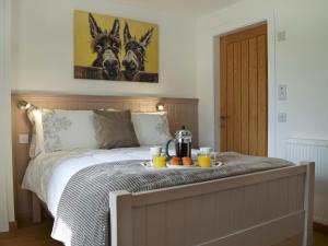 a bedroom with a bed with a tray of food on it at Waterloo Farm House in Bankfoot