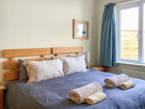 a bedroom with a bed with towels on it at Keepers Cottage - Uk51549 in Kirktown of Auchterless