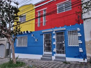 a colorful building with windows and doors on a street at Pousada Solar de Mayo in Curitiba