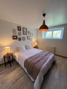 a bedroom with a large bed and a window at L'échappée in Neulliac +47 photos