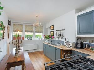 a kitchen with a sink and a stove at Ryegate Cottage in Helmsley
