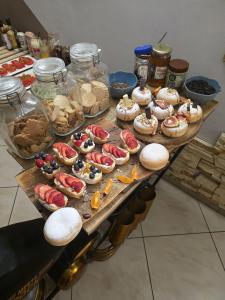 a table with many different types of donuts on it at Villa Ventana Poznań City Free Parking Śniadanie w Cenie in Poznań