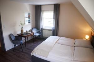 a hotel room with a bed and a desk and a window at Ferienwohnungen Reinhilde - Litzig in Traben-Trarbach