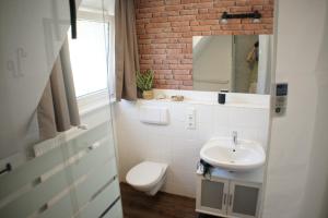 a bathroom with a white sink and a toilet at Ferienwohnungen Reinhilde - Litzig in Traben-Trarbach +3 photos