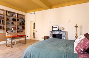 a bedroom with a bed and a fireplace at Elegant Seafront Apartment in Ostia in Lido di Ostia +25 photos