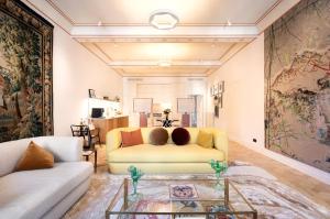 a living room with a couch and a table at Elegant Seafront Apartment in Ostia in Lido di Ostia
