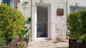 a front door of a house with a chair at Lamia Room Rentals in Matera