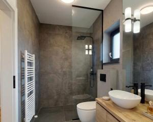 a bathroom with a sink and a toilet and a shower at ANON Mures in Livezeni +18 photos