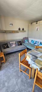 a living room with a couch and a table at Studio lumineux et cosy avec vue montagne 7è étage in Superdevoluy