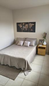 a bedroom with a bed with two pillows on it at Apê estiloso e funcional no coração da cidade in Porto Velho