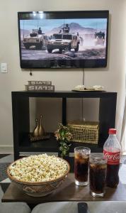 a table with a bowl of popcorn and a television at Apê estiloso e funcional no coração da cidade in Porto Velho