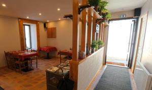 a restaurant with tables and chairs in a room at Le casse noisettes in Gourin