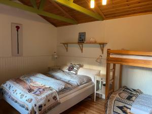 a bedroom with a bed and a desk in a room at Swedish cottage near ocean in Norrtälje