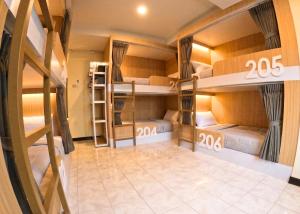 a room with bunk beds with signs on the walls at KPOP Hostel in Karon Beach
