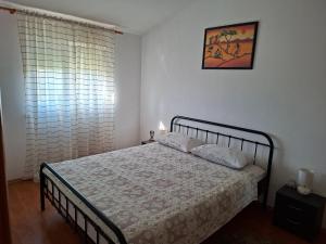 a bedroom with a bed and a picture on the wall at Apartman Marito in Kaštela