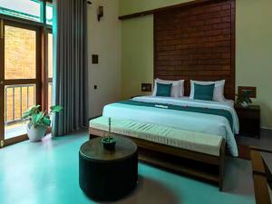 a bedroom with a large bed and a large window at Spacious 2 Bedroom Apartment with Lake View in Tangalle +13 photos
