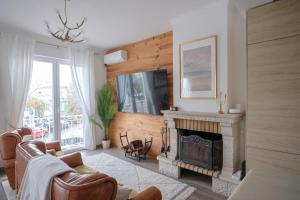 a living room with a fireplace and a tv at Casa Rosa Sé - Luxury Boutique Guest House in Faro