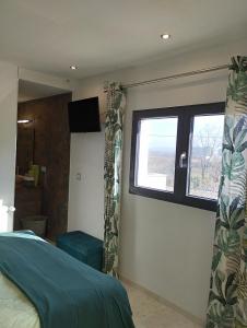 a bedroom with a bed and a window at Chambre 2 pers SPA Piscine in Grospierres