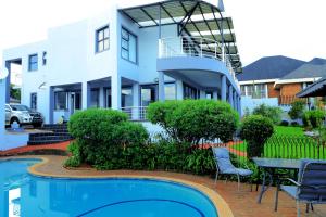 a house with a swimming pool in front of a house at Grand View B&B in Johannesburg