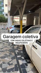 a group of cars parked in a parking lot at Kit net a poucos passos do mar in São Vicente