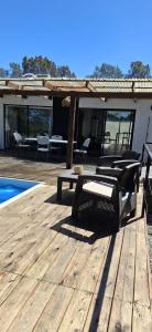 a wooden deck with a table and chairs on a house at NuestroSueño in Villa Serrana +60 photos